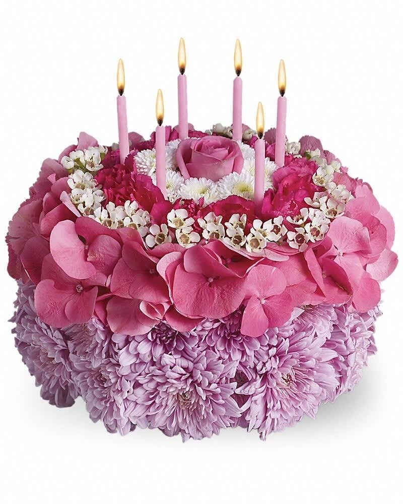 Pink floral cake arrangement with candles and a rose center