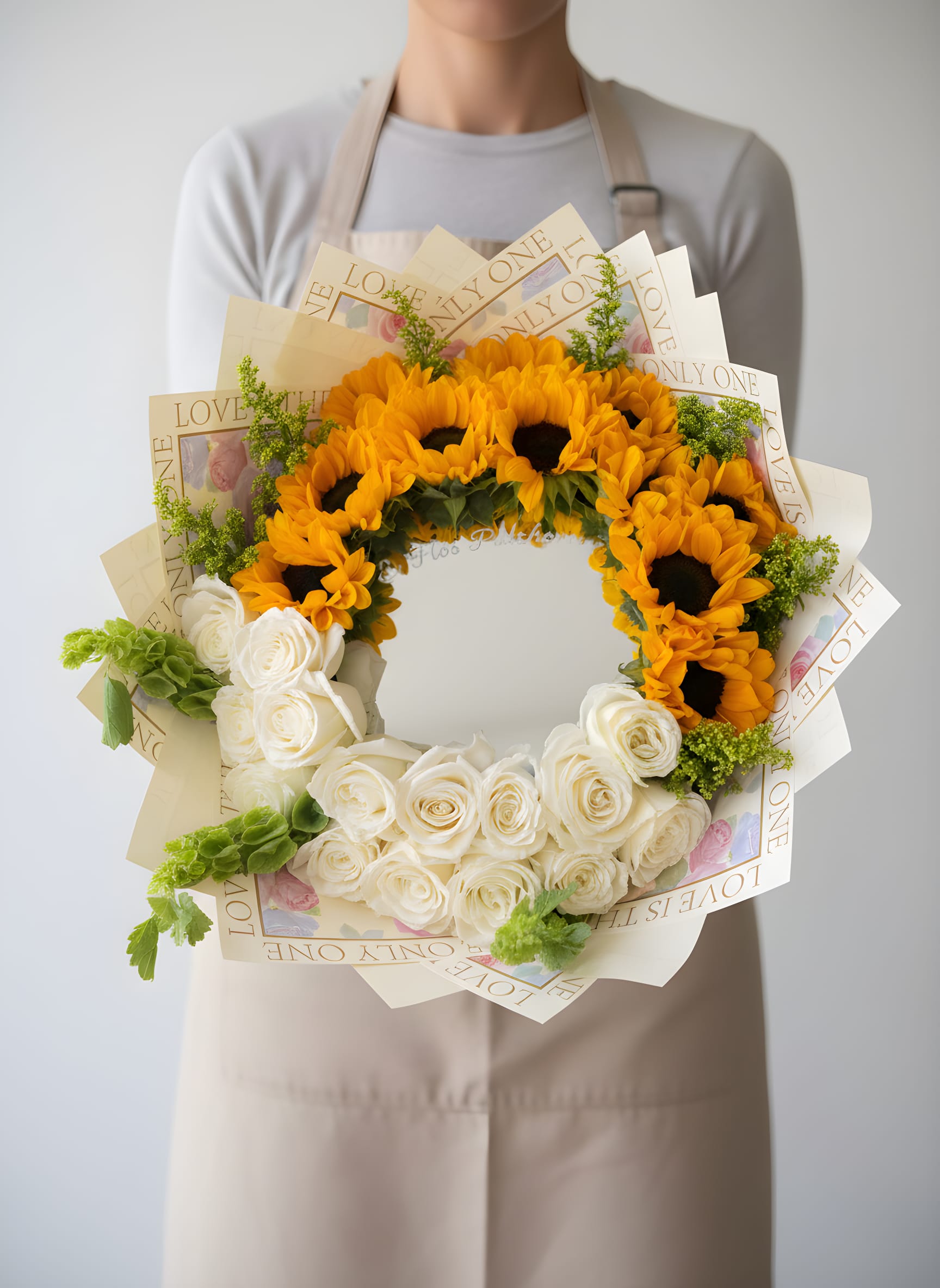 Golden Sunflower Mirror Bouquet - A bold and unique floral design that blends beauty and creativity. This arrangement features vibrant sunflowers paired with elegant white roses, arranged around a central mirror that adds a modern and eye-catching touch.  Perfect for making a statement, this design symbolizes warmth, happiness, and admiration—making it an unforgettable gift for birthdays, celebrations, or special moments.   Ideal for: • Birthdays &amp; celebrations • Unique statement gifts • Graduation &amp; achievements • Brightening someone’s day  Please note: Flower varieties and shades may vary based on availability while maintaining the same color palette, style, and overall design concept.