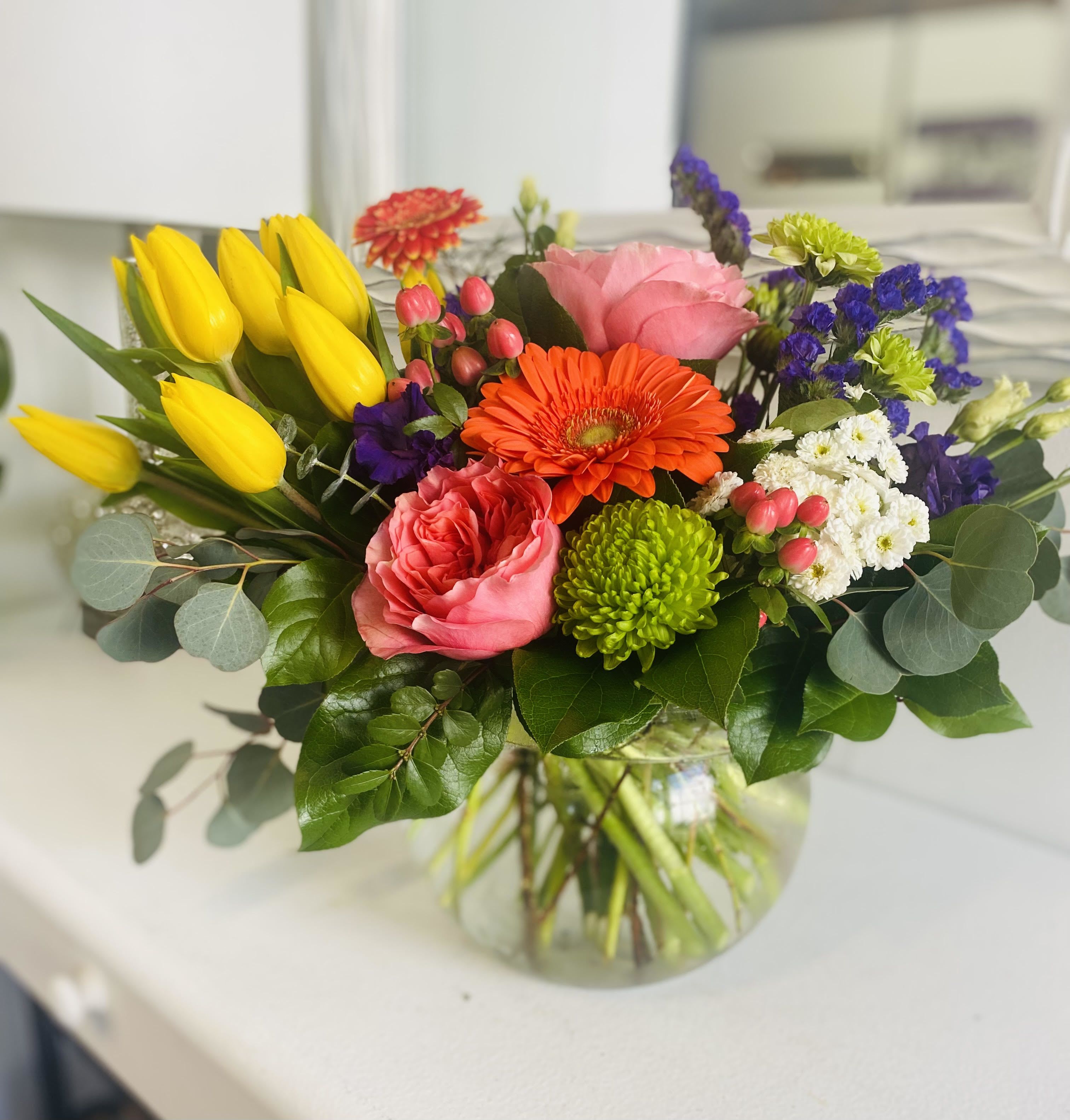 Tulip Time - Perfect for the tulip lover. Tulips and assorted colorful blooms arranged in a clear glass vase.