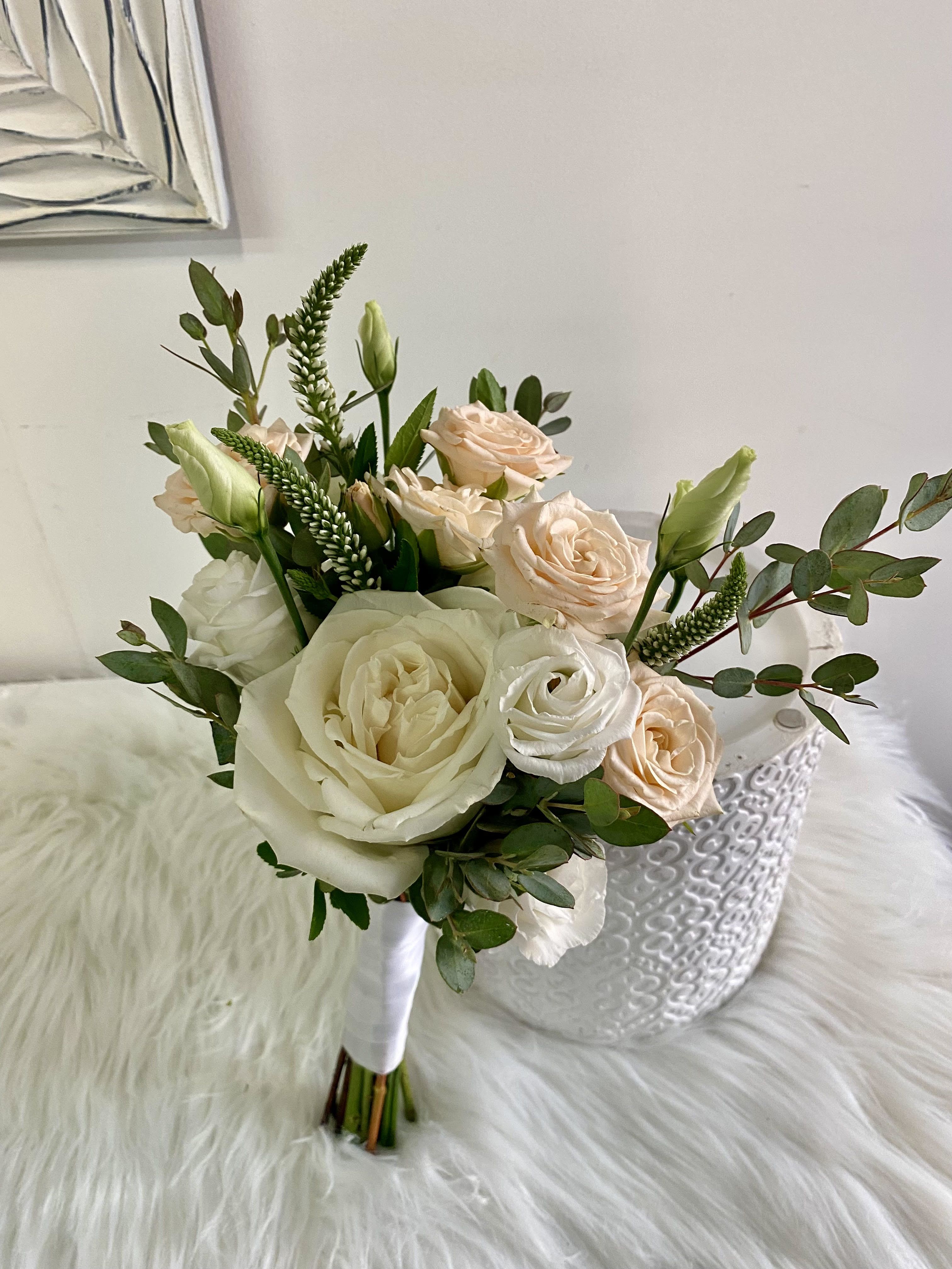 Bouquet of cream and blush roses with greenery