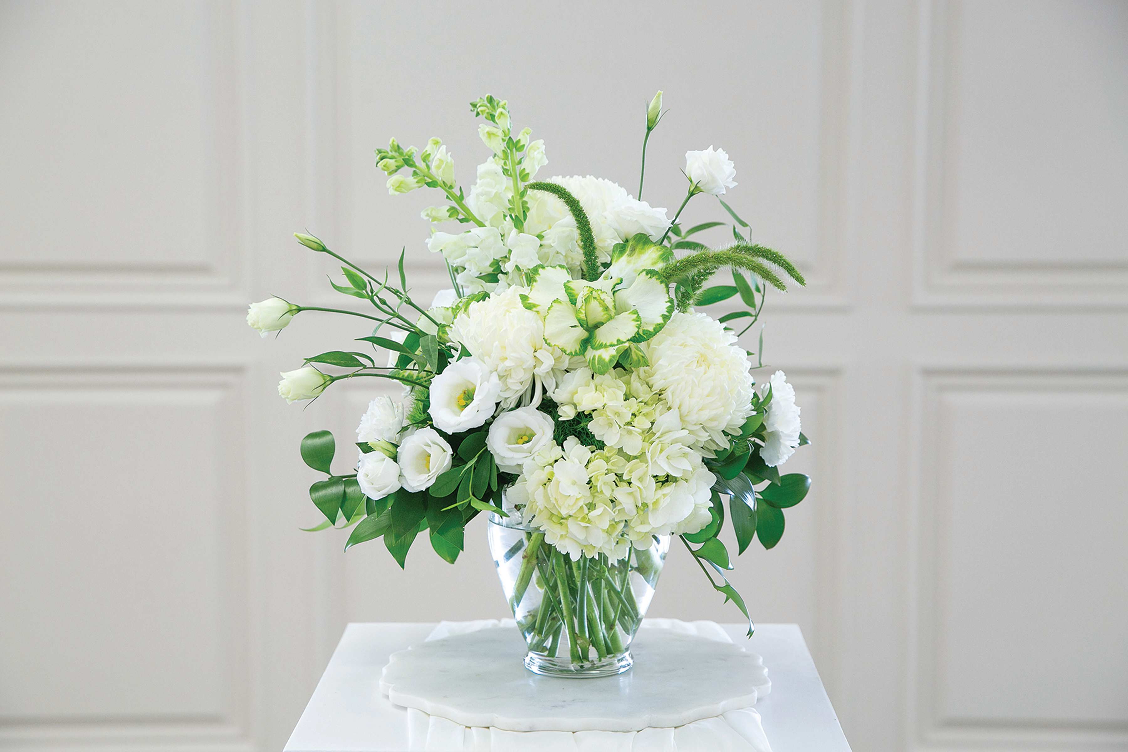 White floral arrangement in a clear glass vase