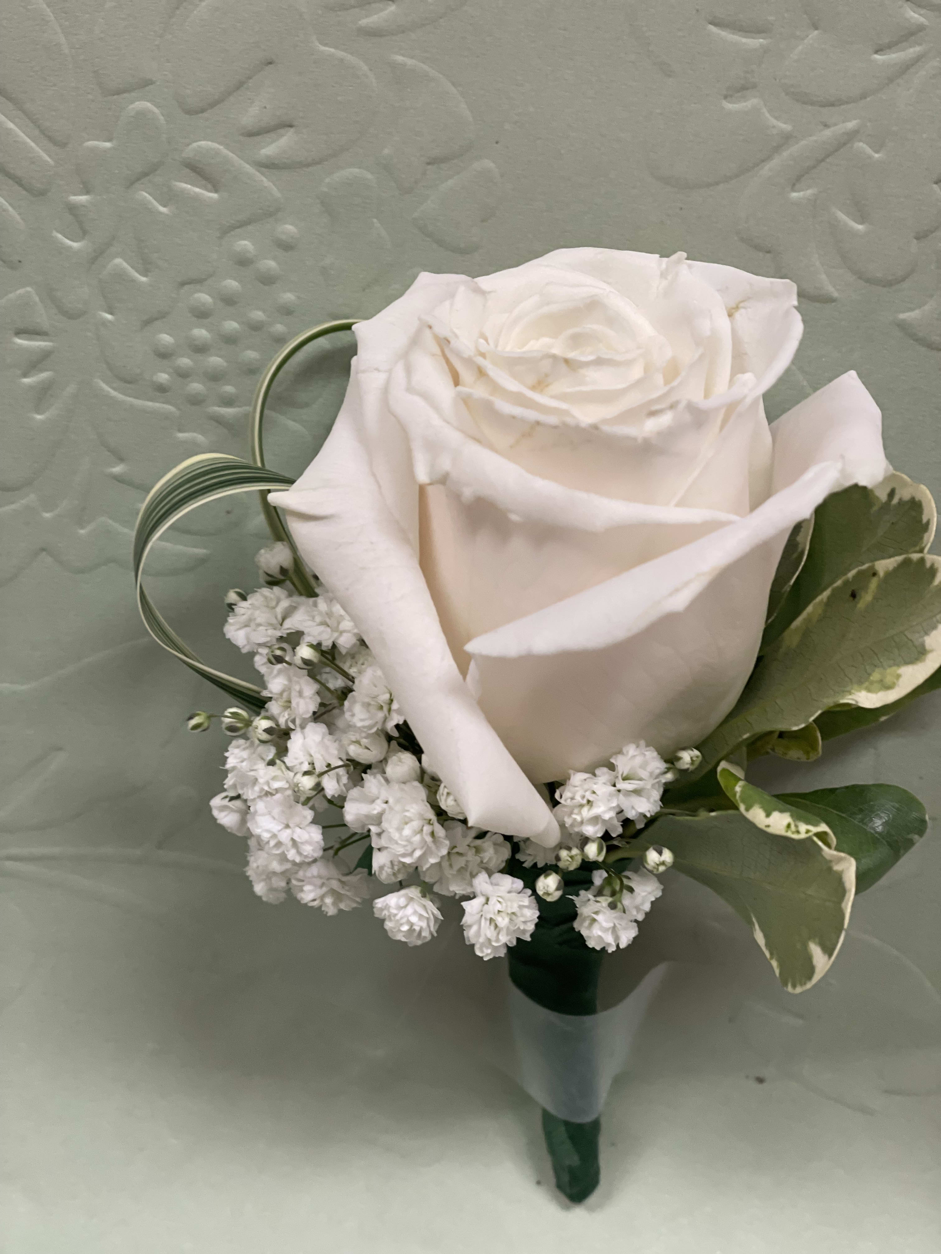 White rose boutonniere with baby's breath and variegated leaves