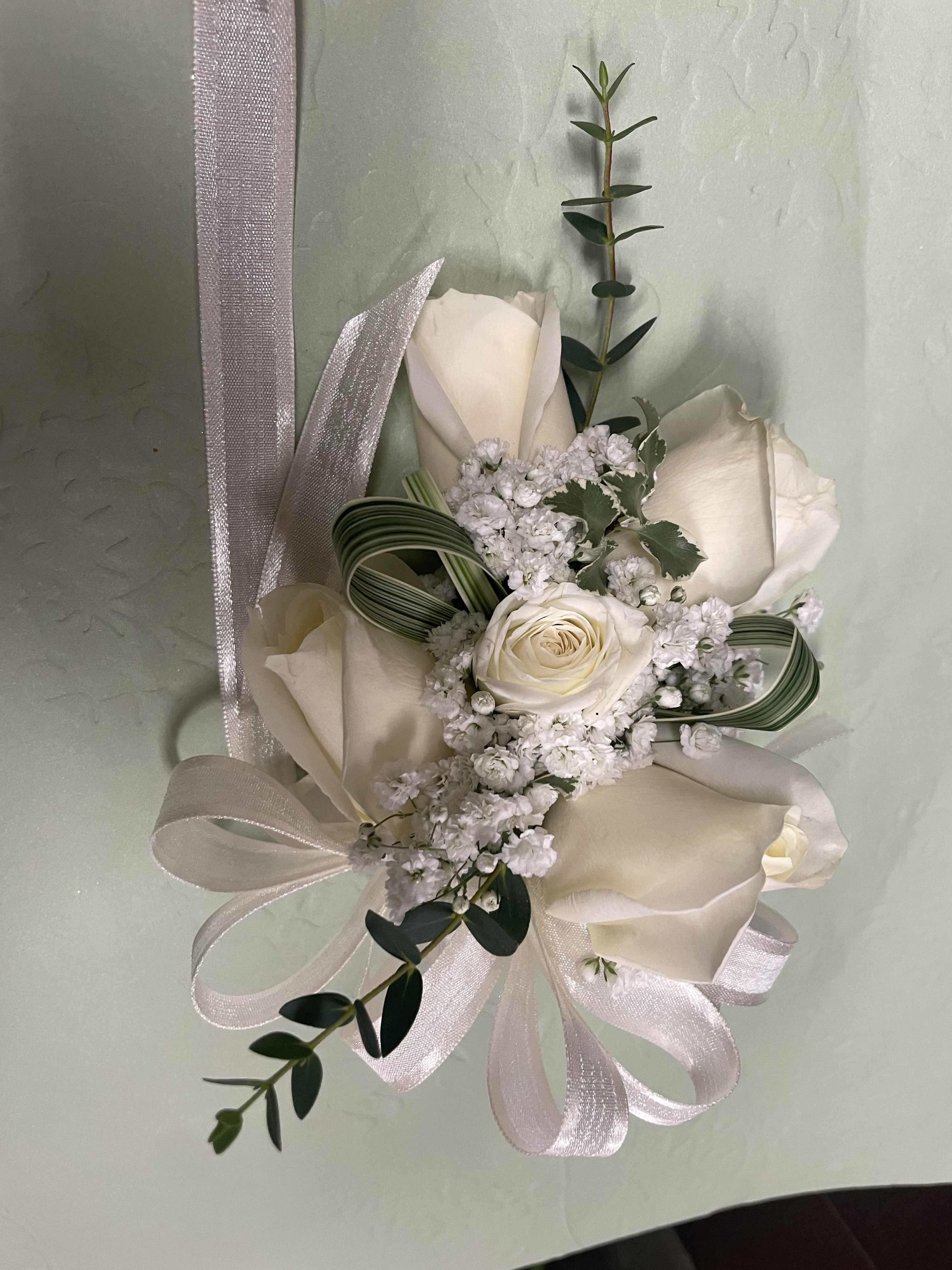 White rose bouquet with ribbon and greenery accents