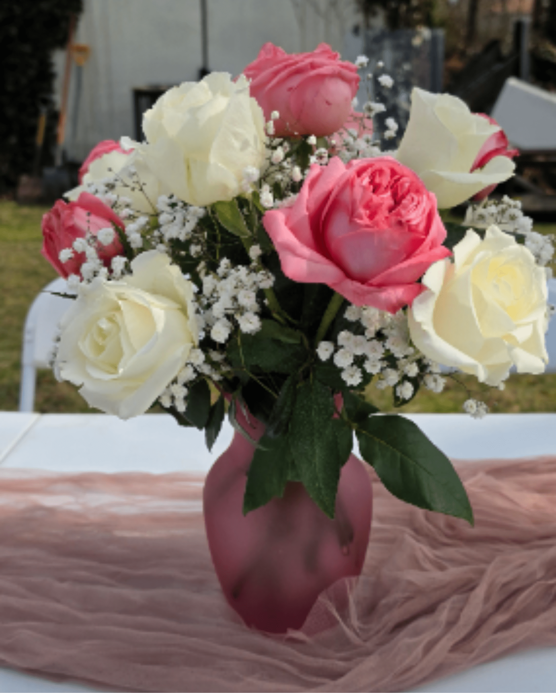 Blushing Elegance  - Discover the perfect blend of tenderness and sophistication with our "Blushing Elegance" arrangement. This handcrafted design brings together the purity of white roses with the warmth of pink roses, creating a charming visual contrast, all accompanied by the delicate texture of baby's breath. These flowers are ideal for expressing gratitude, celebrating an anniversary, or simply brightening any corner with a touch of natural freshness and romantic style. Approximate dimensions: 13" H x 11" W