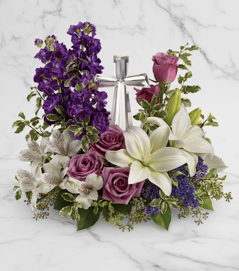 Grace And Majesty Bouquet - A bouquet to remember. This glorious garden of roses, lilies and alstroemeria surrounds a gleaming Crystal Cross. It's a radiant, reverent expression of faith that will be appreciated for years to come.