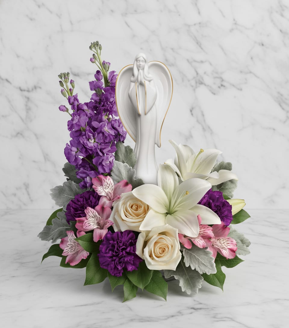 Beautiful Heart Bouquet - An elegantly unique expression of your deepest condolences, this majestic mix of crème, white and lavender blooms includes fragrant roses and lilies to refresh and rejuvenate their spirits. Nestled among the blooms is a graceful angel sculpture - a serene, spiritual keepsake they'll always treasure.