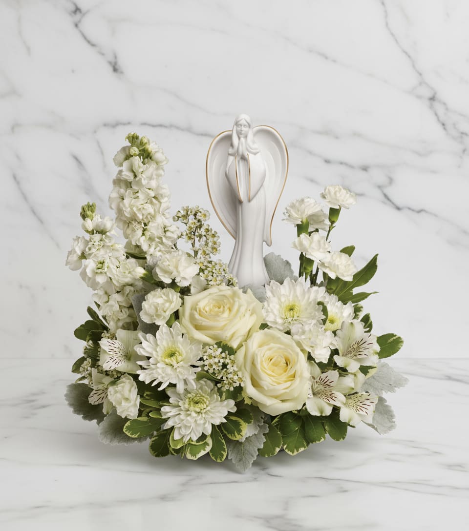 Guiding Light Bouquet - Peaceful and majestic, a graceful angel rests amongst fragrant, snow white roses, alstroemeria and stock - a touching tribute to a bright life and your unending support.