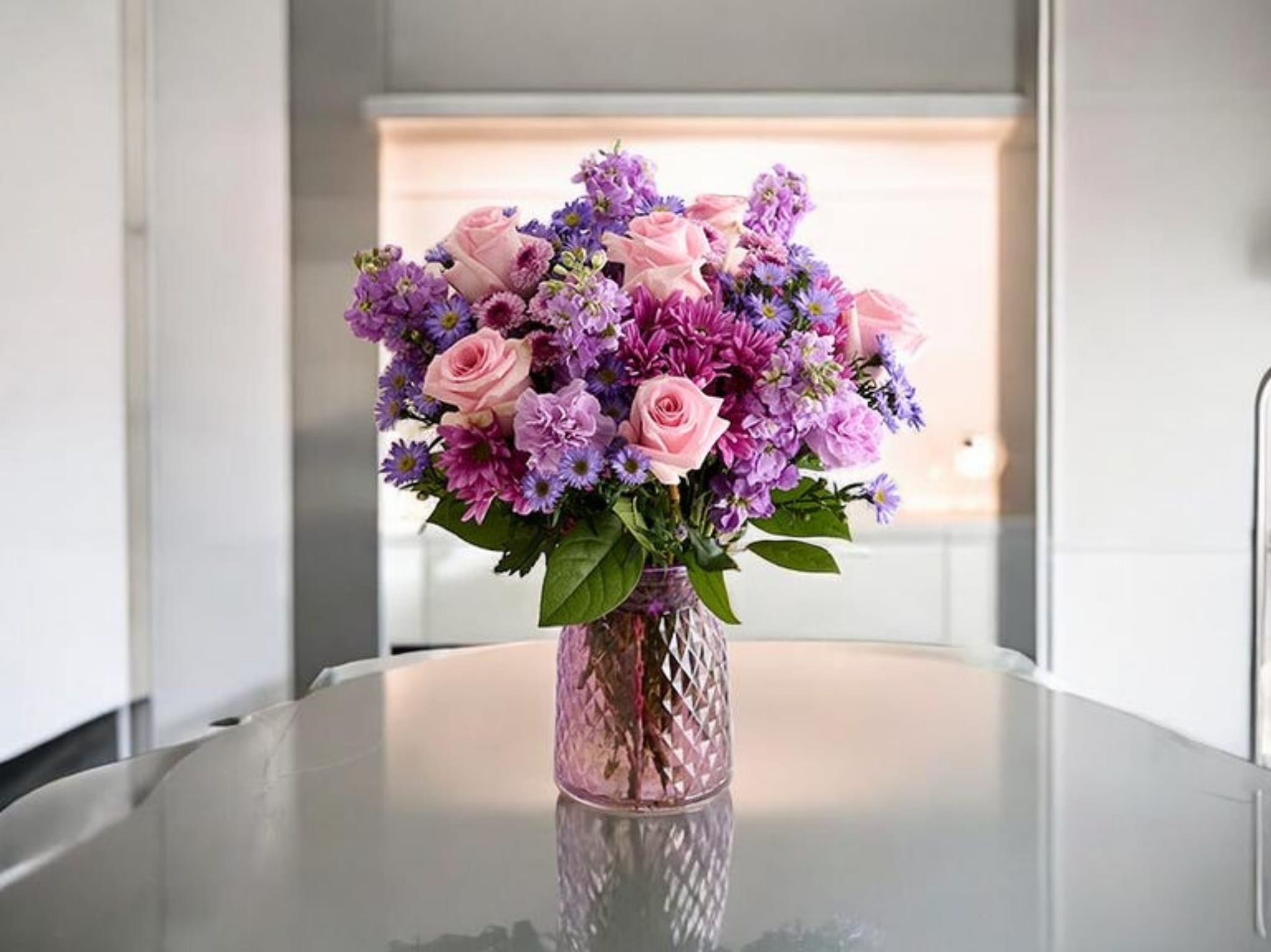 Radiant Bloom Vase - vibrant arrangement of fresh flowers beautifully displayed in a textured glass vase. Designed to brighten any space with rich colors and natural elegance—perfect for gifting or adding a lively touch to your home.