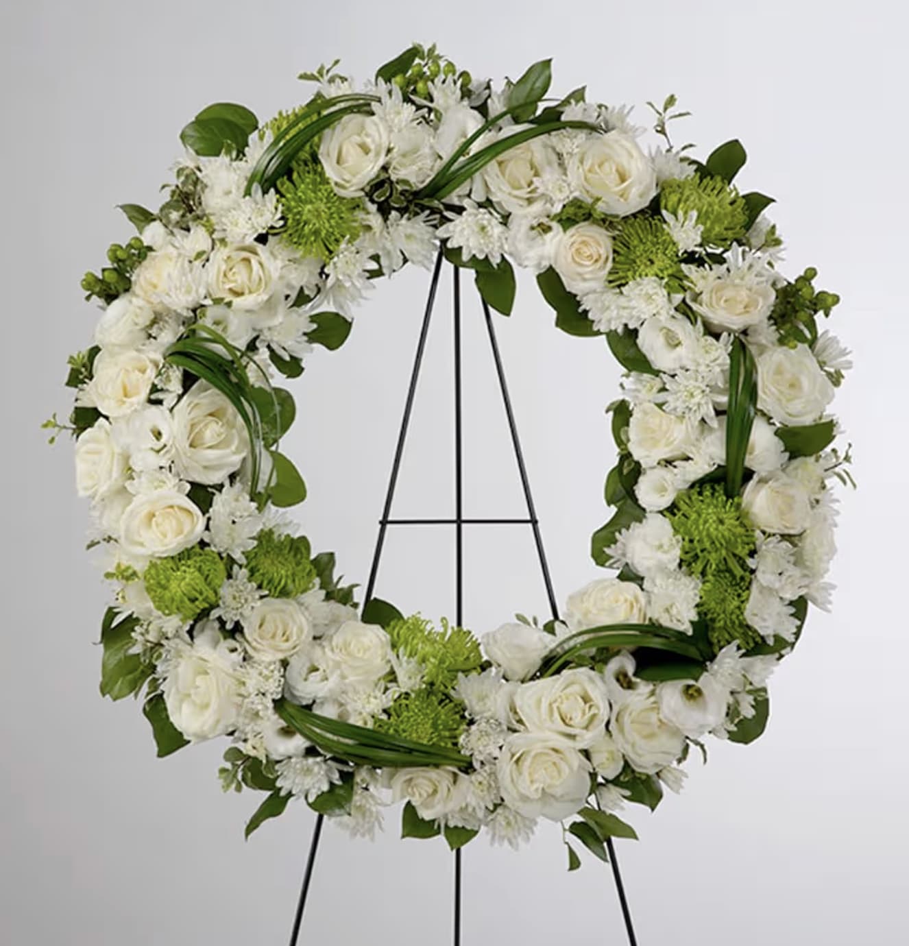 Sympathy Wreath - A beautiful white and green tribute wreath that calms, this easel arrangement celebrates a full life and a peaceful passing. 