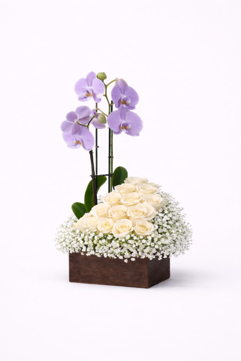 Cream roses and lavender orchids in a wooden box