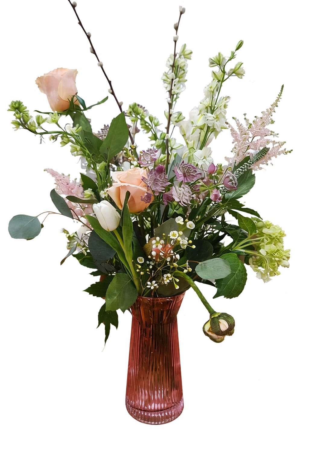 A Spring Fling Bouquet - Dutch tulips, hydrangea, veronica, wax flower, astilbe, anemonies, larkspur, roses and pussy willows arranged in a tinted glass vase