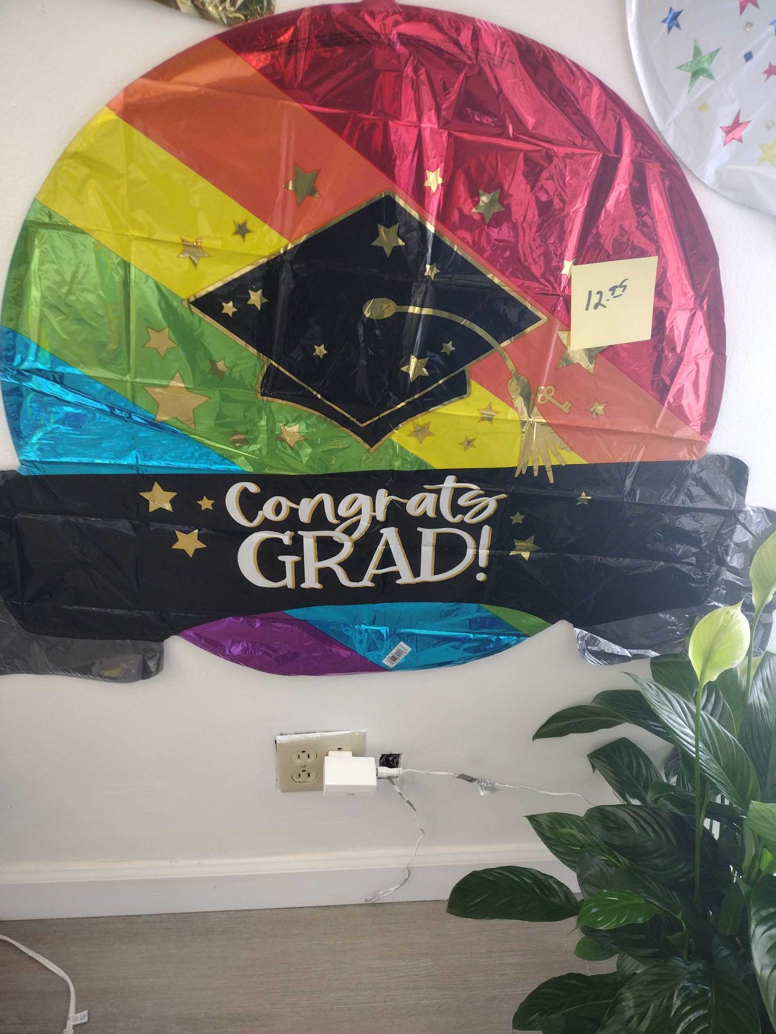 Graduation-themed foil balloon with a cap and "Congrats Grad!" text