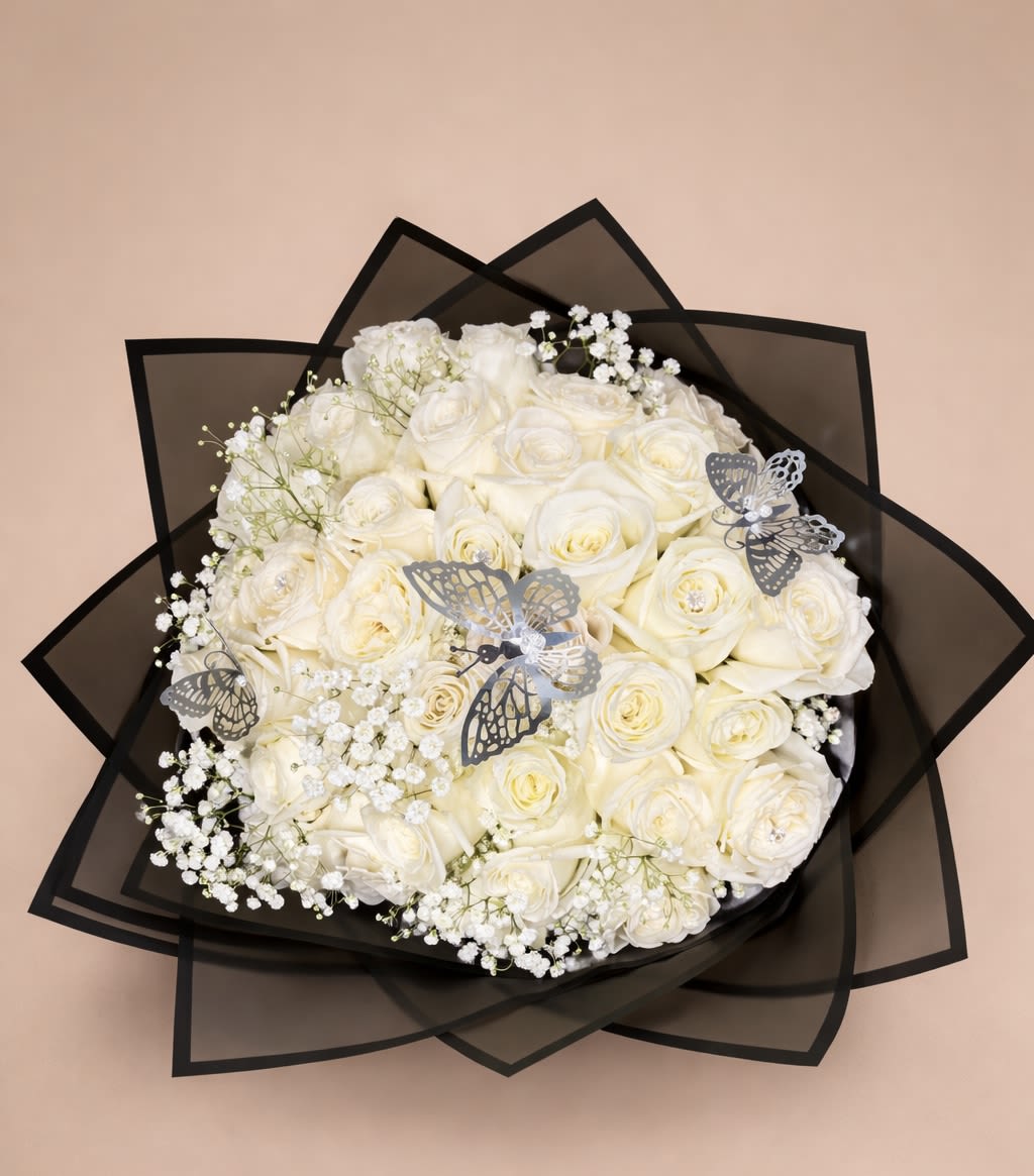 Round bouquet of ivory roses with baby's breath and silver butterflies in black wrap