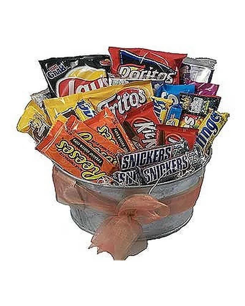 Metal bucket filled with assorted chips and candy bars, wrapped with a soft peach bow