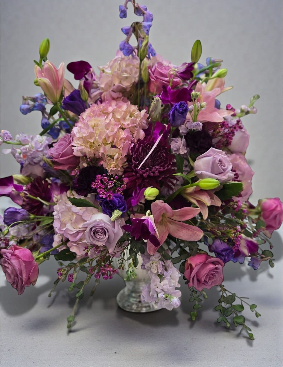 Lavender and pink floral arrangement in a clear glass vase