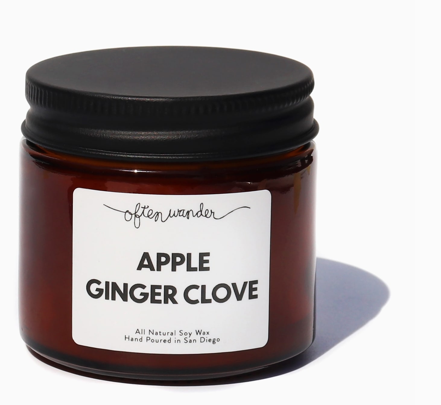 Amber glass jar candle with black lid and Apple Ginger Clove label