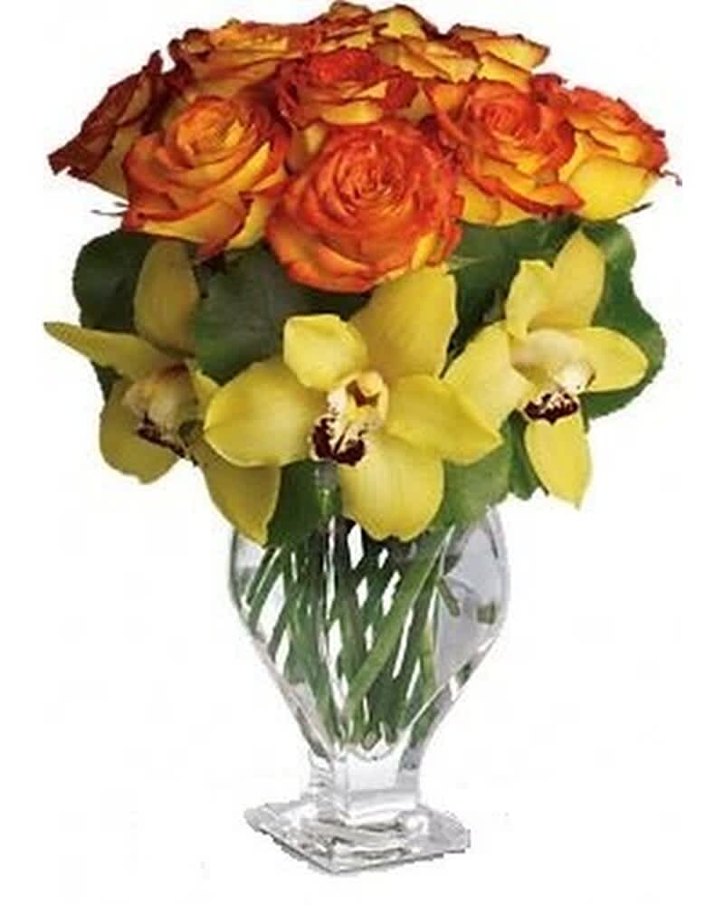 Arrangement of orange roses and yellow orchids in a clear glass vase