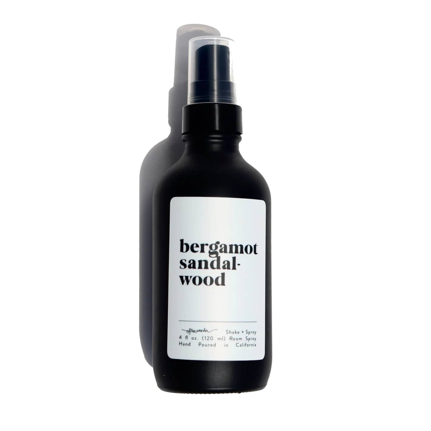 Matte black spray bottle with a white label reading bergamot sandalwood.