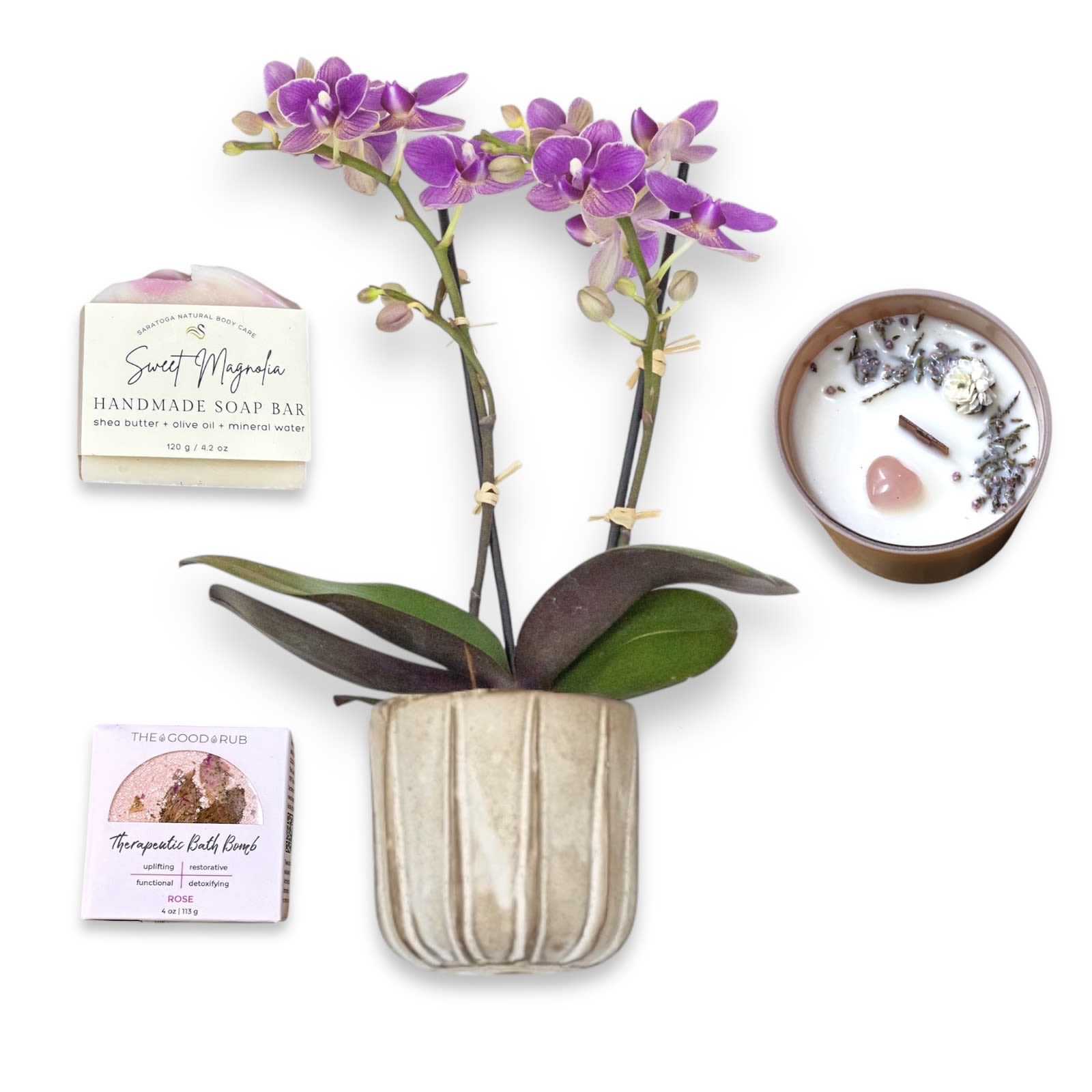 Self-Love Gift Set - SELF-LOVE GIFT SET  Sol Ambiance is proud to support these artists and makers, and other small businesses, to make our community and the world a better place. Enjoy your gift set!  Mini orchid planted in Accent Decor’s ceramic pot.  Lit Rituals "Spring Flowers" 100% Soy Candle. 7oz.  A beautiful Pink container with a fresh and florally scent, topped with dried lavender buds and a pink Rose Quarts heart.  Saratoga Natural Body Care 4.2oz Bar of Soap.  In the scent "Sweet Magnolia". Made with shea butter, olive oil and mineral water. Moisturizing, Nourishing, and Gentle on skin. No Sulfates or GMOs.   The Good Rub Therapeutic Bath Bomb in scent "Rose. 4oz. Botanically infused and responsibly sourced anti-inflammatory ingredients will benefit the whole body. Rose Oil helps promote beautiful, radiant skin. Combine that with a freshly dried rosebud and rose petals and you have yourself a rich, beautiful aromatherapy experience! 