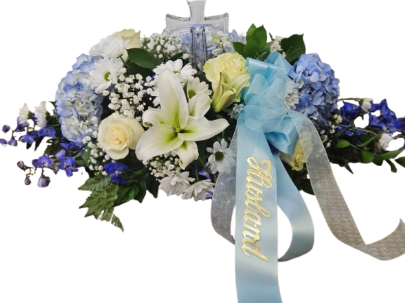 Blue and White Casket Cover with Crystal Cross - Blue Hydrangea, Delphinium, White Lilies, roses, daisies and baby's breath with crystal cross keepsake. Specialized Ribbons an extra charge of $10.00.