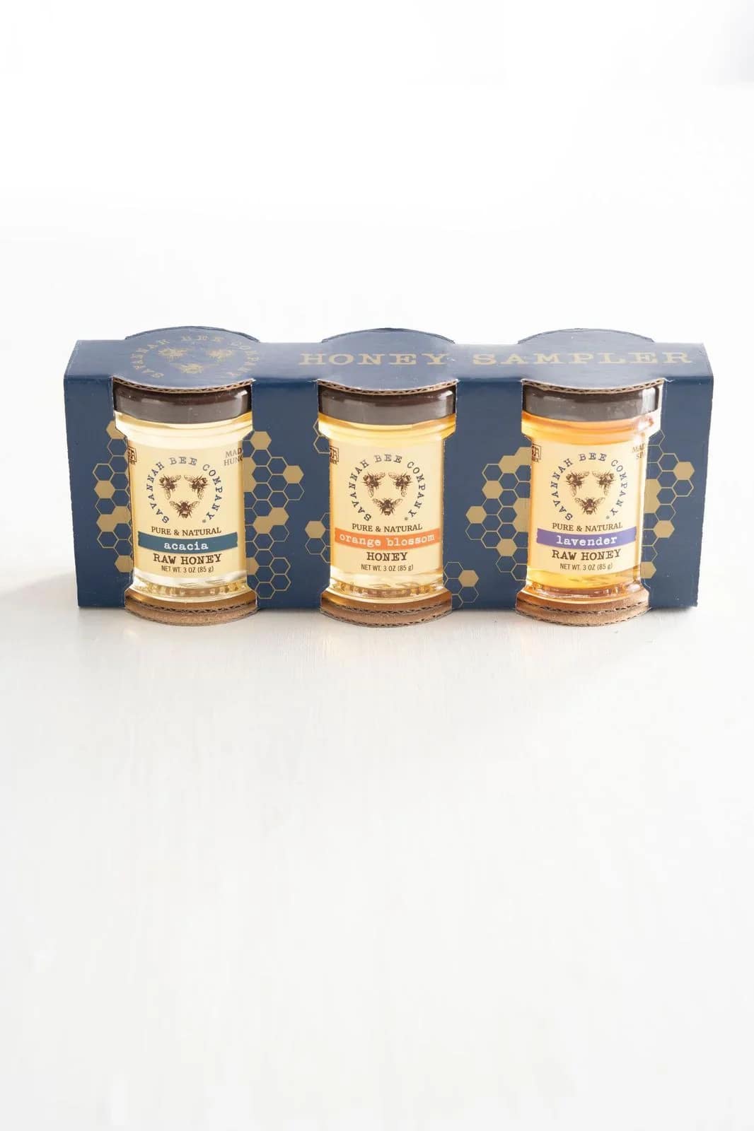 Three jars of honey in a blue sampler box
