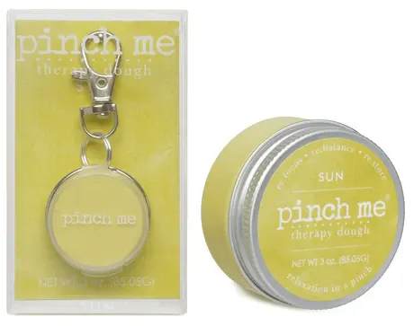 Yellow tin of therapy dough with a keychain in packaging