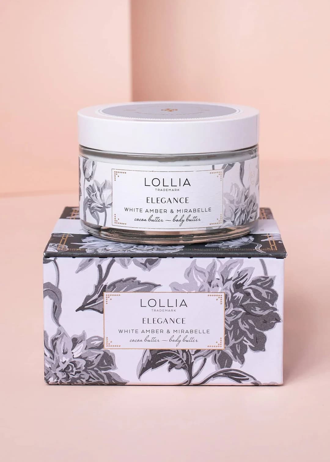 Jar of body butter on a floral-patterned box