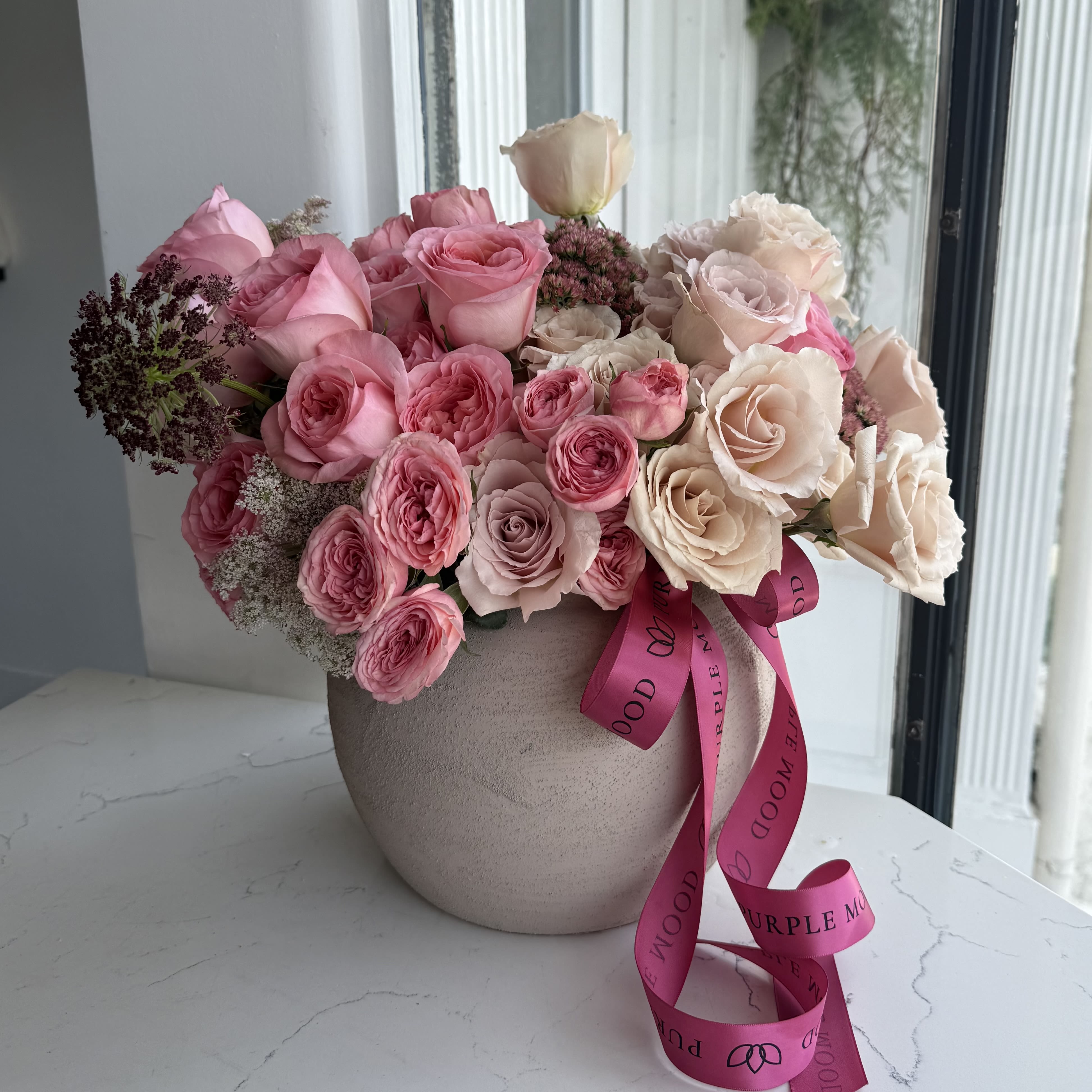 Blush &amp; Latte Vase -  A soft, neutral floral arrangement in warm blush and latte tones, featuring a curated mix of premium roses and delicate garden textures. Designed to complement modern interiors, this piece brings a sense of calm, elegance, and understated luxury to any space.  • Premium garden and classic roses • Neutral palette: blush, latte, ivory • Perfect for gifting or home décor • Arrives arranged in a vase  Please note: flower varieties and shades may vary slightly based on seasonal availability.