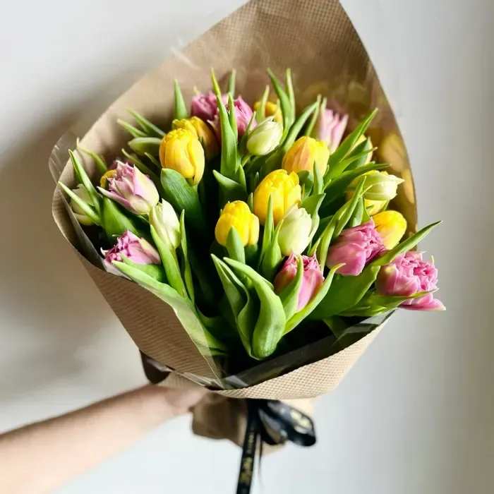 Tulip Bunch (Premium Size Pictured) - Celebrate timeless beauty with our Just Tulips bouquet—vibrant, hand-tied tulips in a stunning mix of colors. Perfect for anniversaries, birthdays, or simply brightening someone's day.  For an added touch, pair it with a handcrafted vase from Wolftever Creek Pottery. Each piece is locally made with love and designed to be a lasting keepsake.  Simple. Elegant. Unforgettable.  Product ID: Tulip-Bunch