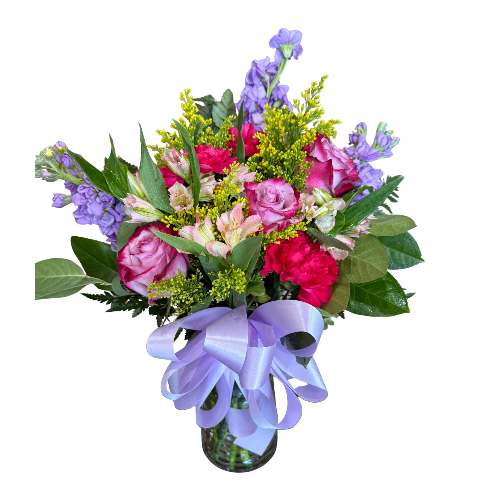 Lavender Bliss  - Soft and full of charm—this beautiful bouquet is designed to make someone feel truly special. Featuring a dreamy mix of lavender blooms, blushing roses, vibrant carnations, and fresh seasonal accents, it’s arranged in a clear glass vase and finished with a delicate ribbon for the perfect touch.