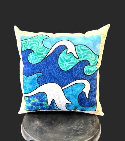 A Day At The Beach Pillow - A Day At The Beach Pillow brings calm coastal style to a casual gift or home refresh-the perfect pick-me-up for someone who loves seaside colors. This square decorative pillow reads like an abstract seascape, making it a thoughtful housewarming gift, a cheerful birthday accent, or a simple "thinking of you" present for the person you're imagining relaxing by the water.  The design features layered wave-like shapes in shades of blue, teal, and white with dark, hand-drawn outlines and a pale cream border that frames the composition. The textile-art quality and cool color palette create a soothing, modern vibe that pairs well with neutral sofas, wicker chairs, or a breezy porch setting. Sized and finished for everyday use, it's an easy way to add coastal texture and color to any room.