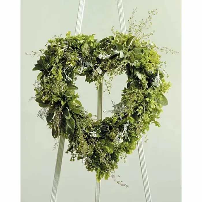 Foliage Heart – Open Heart Wreath with Lush Greenery - Make a meaningful statement with our Foliage Heart, an elegant open heart wreath crafted entirely from lush green foliage. Designed for depth, texture, and natural beauty, this wreath is a tasteful and timeless tribute for funerals, memorials, or honoring a loved one.  Expertly arranged by our florists, the Foliage Heart showcases layered textures and rich greenery, creating a striking, three-dimensional display that conveys sympathy and remembrance with understated elegance. Its simple yet sophisticated design makes it a thoughtful gesture or a refined addition to any memorial service.  Ordering Information: Handcrafted with care using premium fresh greenery. Please place orders in advance to ensure availability.  Note: Greenery types may vary slightly based on seasonal availability.  Product ID: 1611 