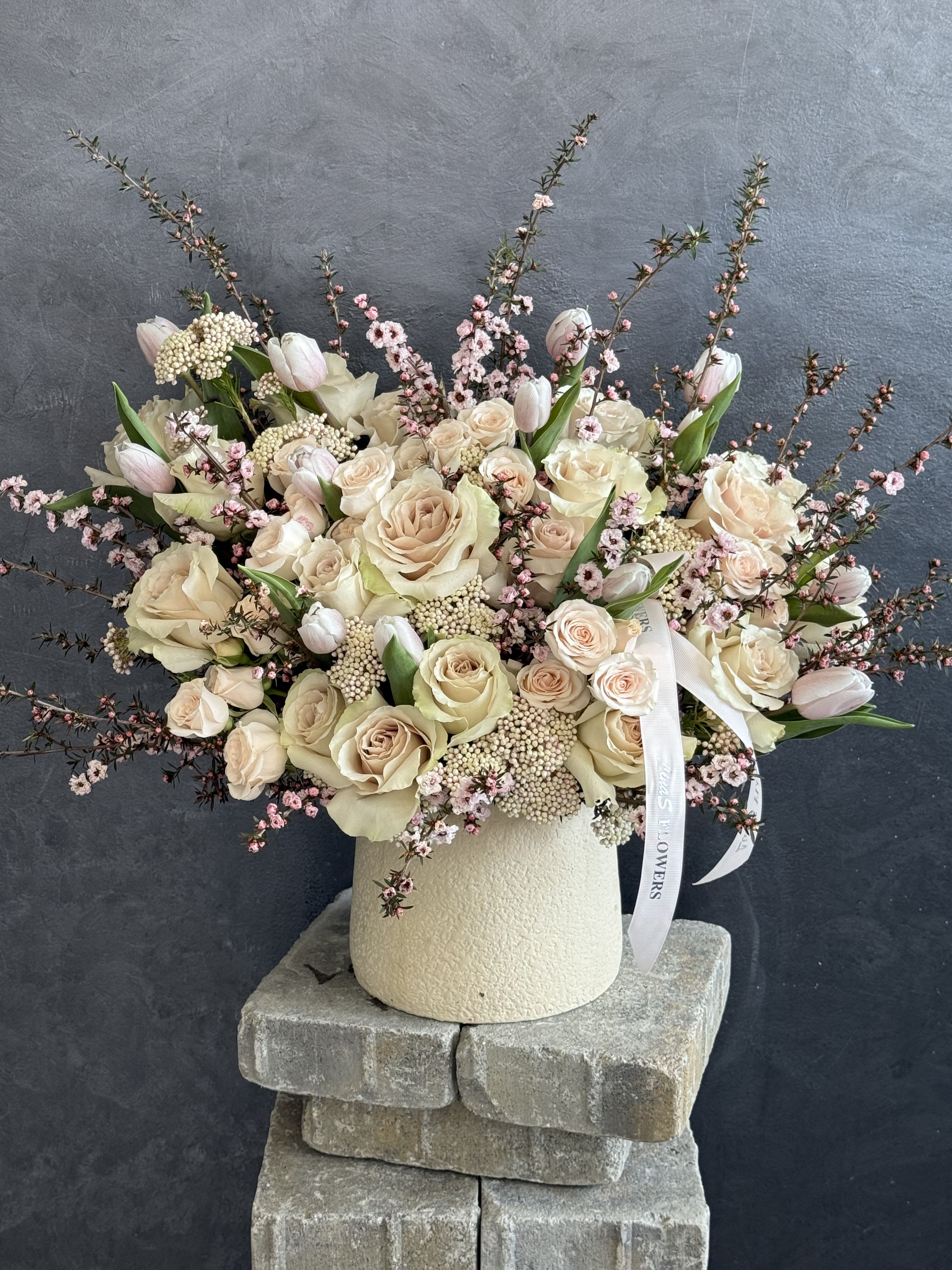 Silk blush  - A soft and elegant blush flower arrangement featuring delicate shades of pale pink, ivory, and nude tones. Designed with airy textures and graceful blooms, it creates a romantic, timeless look perfect for any refined setting.