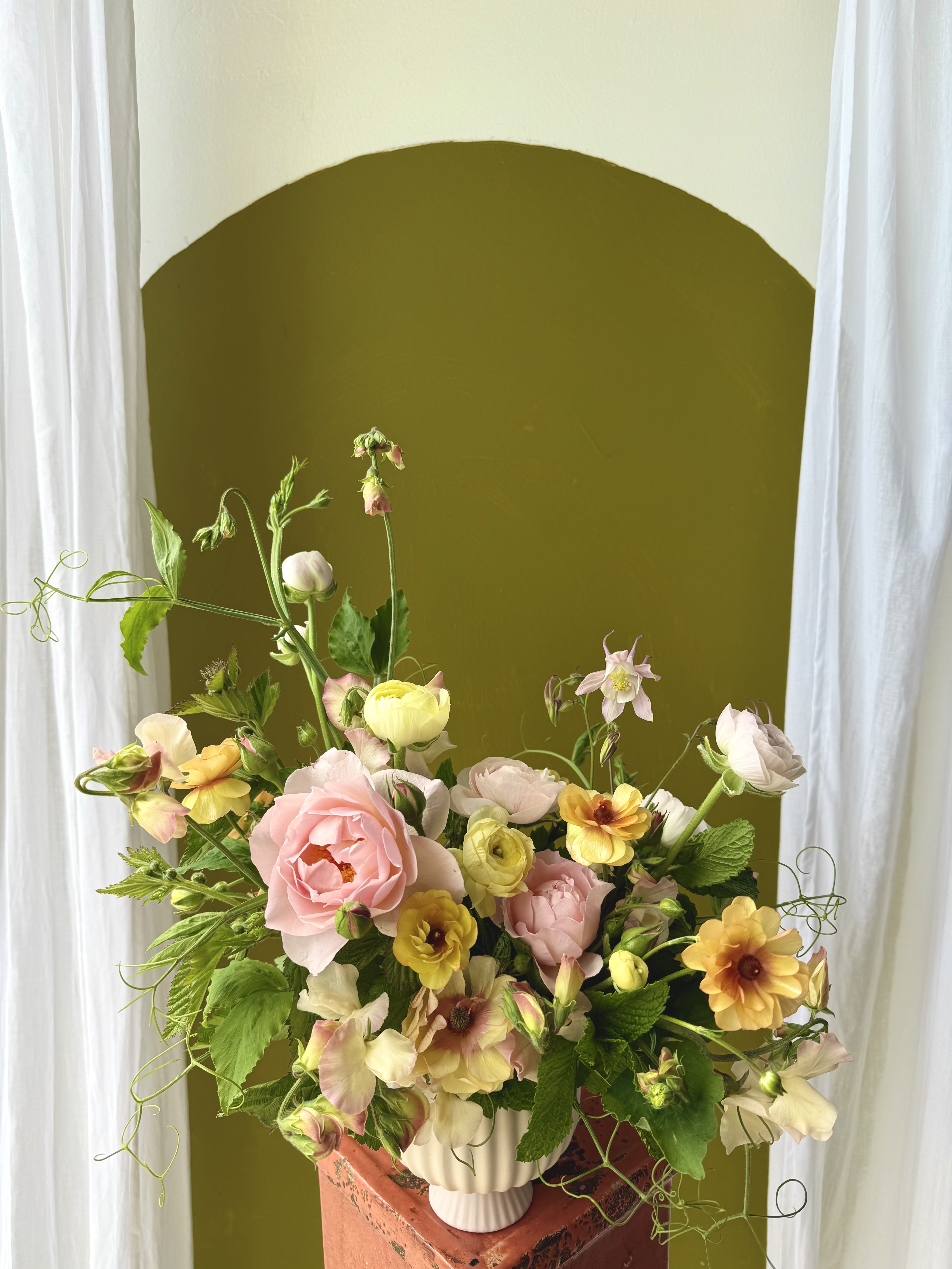 Soft Designer's Choice - If you’re familiar with what we do and want us to create something distinctive and special for you, this is the perfect choice! Pictured is not representational of color or flowers included. However, you can expect the "soft" designer's choice to feature a variety of pastel, white, and lighter colored tones for a gentle and idyllic design.  *Standard size pictured*  Concerning Seasonality: As a seasonal, locally-focused florist, we have different product to work with each week. Our focus is on creating a unique piece for each customer, with blooms that are fresh from local farms and growers. While the flower varieties and colors may vary, the quality and freshness will always be the best. It is an honor to have our customers' trust and confidence in our abilities and artistic eye.   Delivery Policy: Pick-ups at the studio are available after 2pm. Our daily delivery time frame is typically between 12- 3 PM. Please specify if you require a certain delivery time and we will do our best to accommodate it, or we will call you if we cannot. Please include any gate codes if applicable! If there is no answer at the door, our delivery person will leave the flowers by the doorstep in a weather safe location or contact you to reschedule the delivery.  Completing your order acknowledges that you have read and understand our delivery policies. 