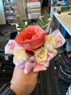 Small bouquet of pink and cream roses with ribbon wrap