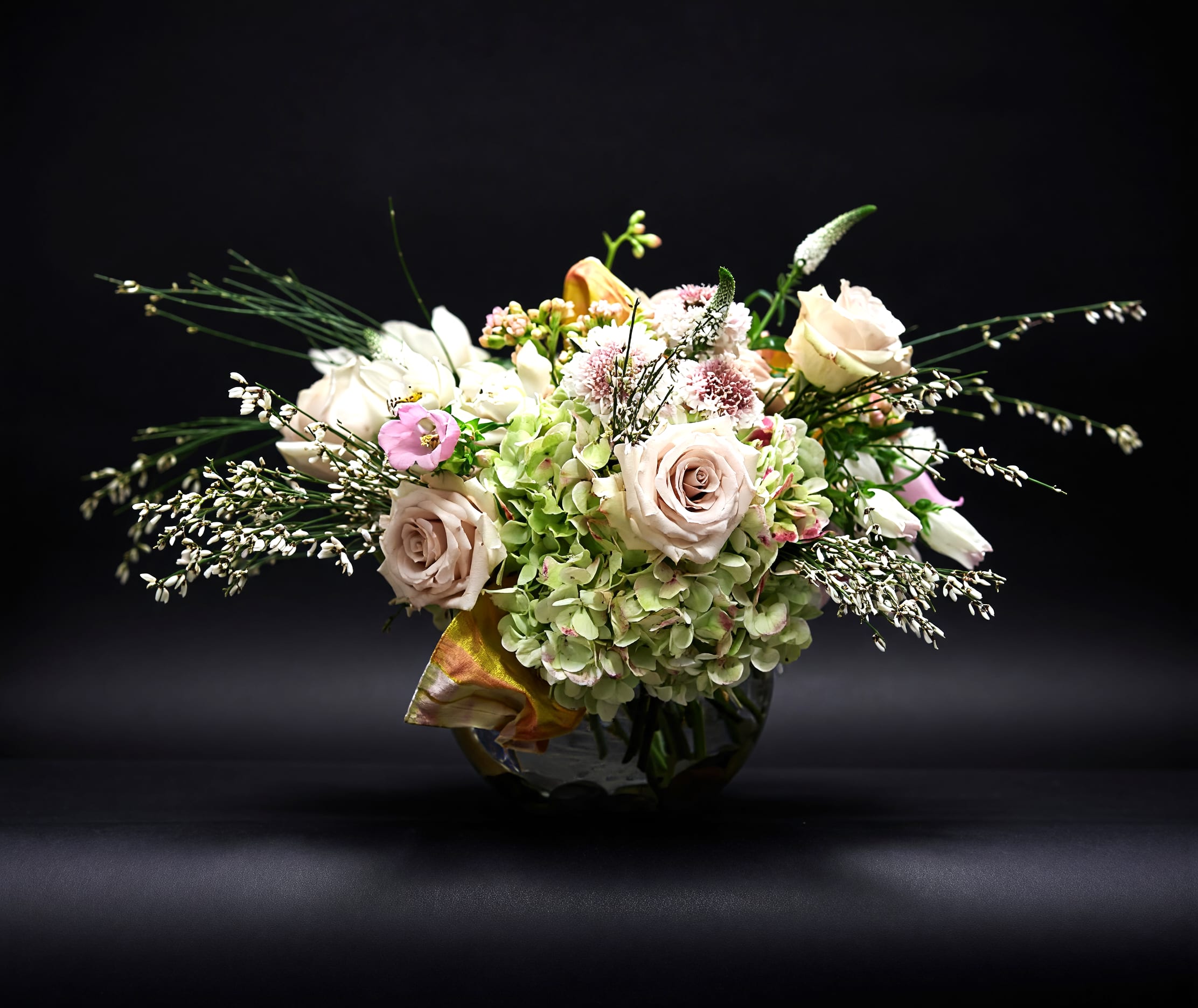 Toujour Paris - The perfect way to say, "Bonjour"!  A lovely romantic composition of classic flowers in subtle hues and varied textures. A rich silk ribbon woven into the arrangement seals the deal. Presented in a clear glass bubble bowl with exposed stems.