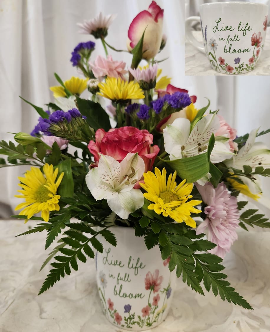 Summer Vibe - In a ceramic mug this pretty arrangement has everything summer. Roses, Daisies, Chrysanthamums, Alstromerias, Purple statiche and seasonal greenry will brighten any room.