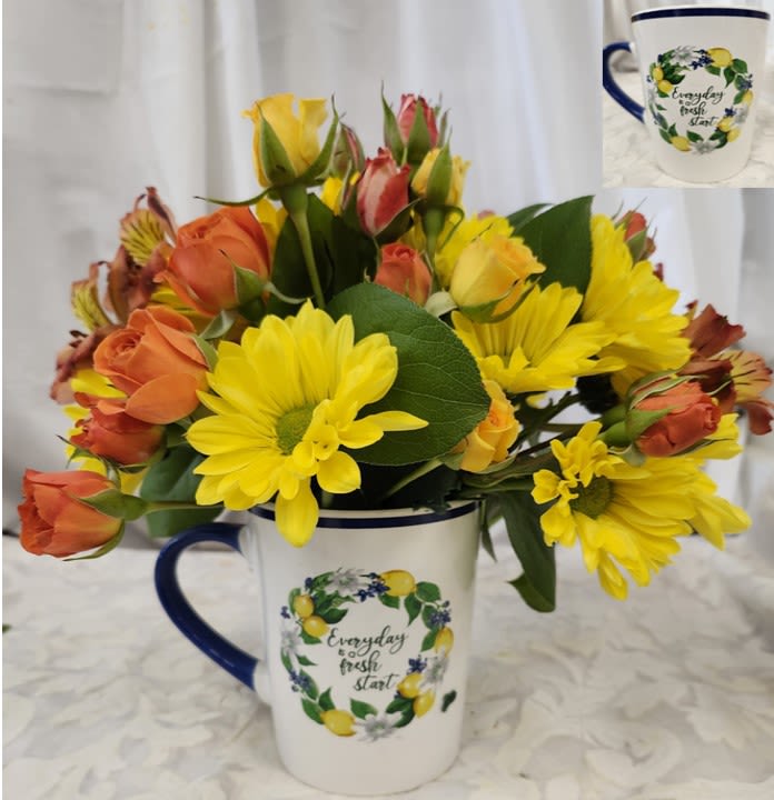 The Best Is Yet To Come - In a mug with a motivational vibe this arrangement is bright with Yellow Daisies, Spray Roses, Alstromerias and Seasonal Greenry.