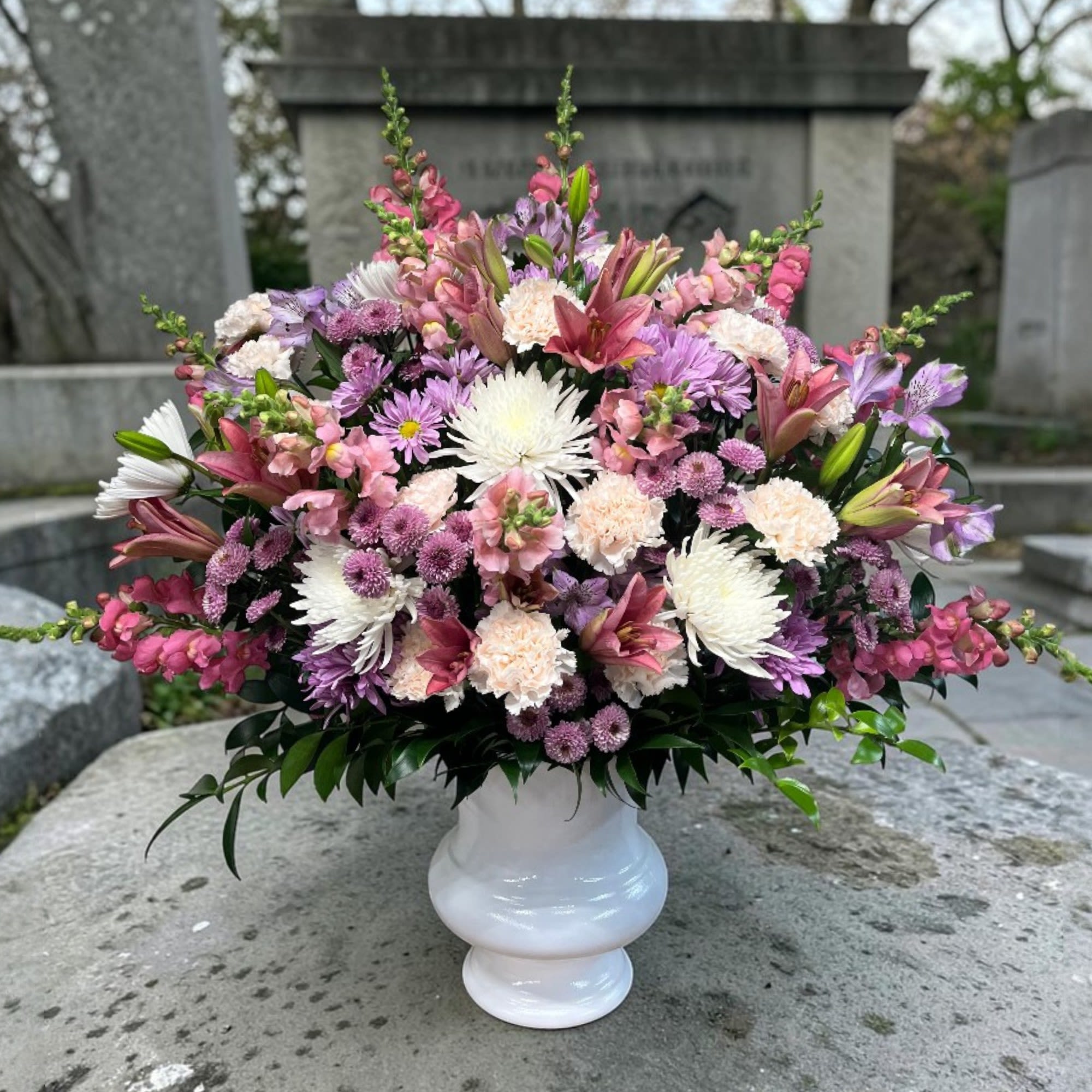 Forever In Harmony - This pink, lavender and white urn funeral arrangement is a lovely tribute and fitting for any type of ceremony. 