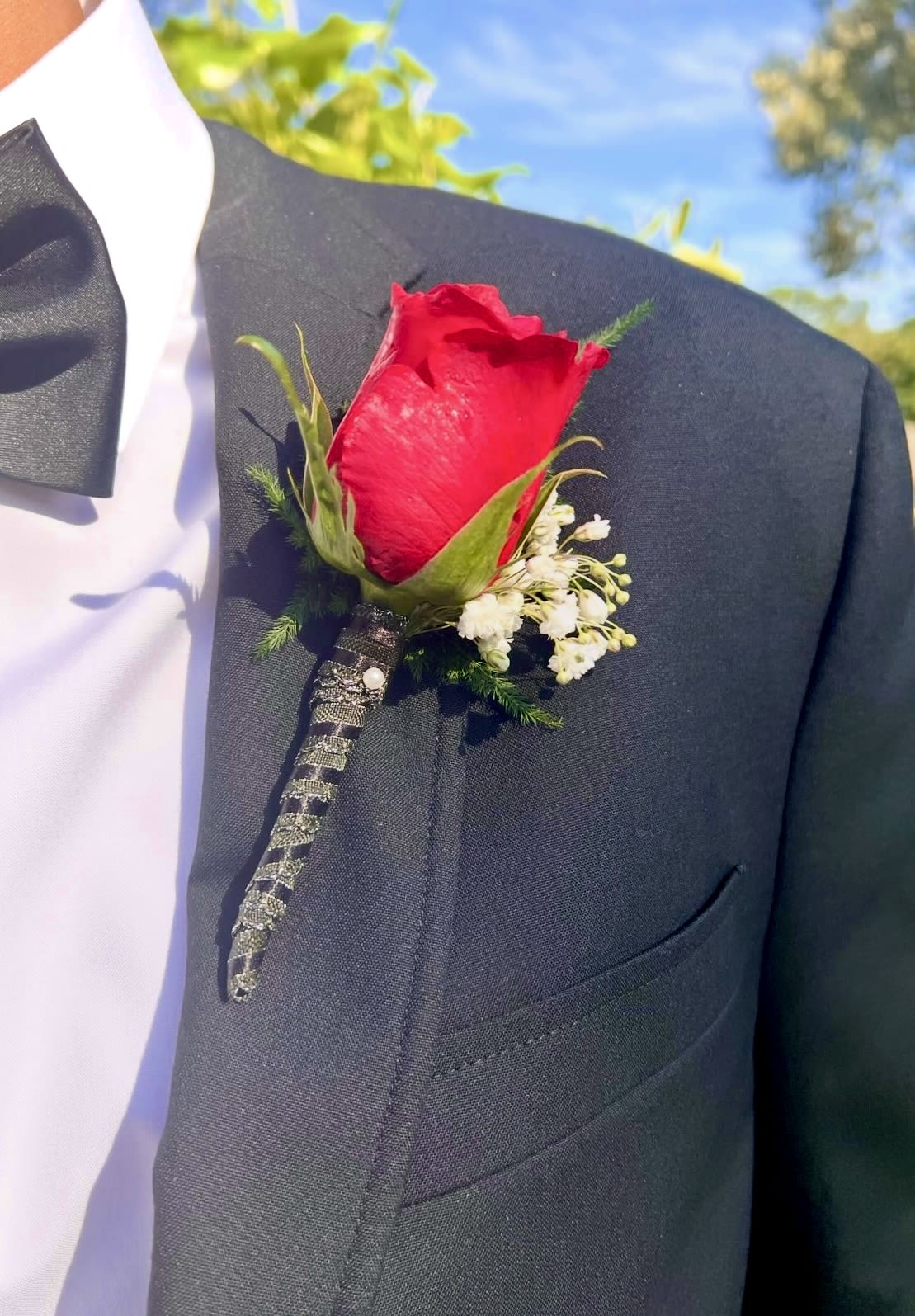 Boutonniere and Bouquet  - A set of  matching Boutonniere and Bouquet created with red roses , accents and matching  ribbon . If you have a particular color or style in mind ,give us a call and we will create one for you. 