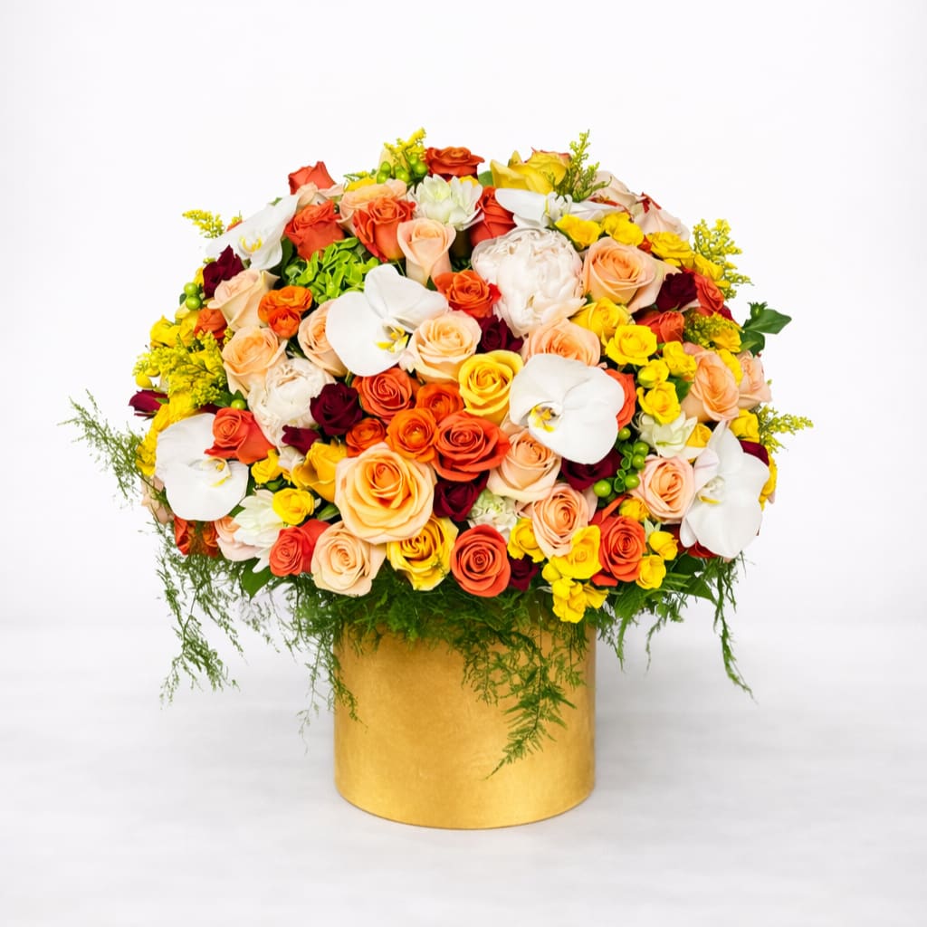 Mixed bouquet of roses and white orchids in a gold box