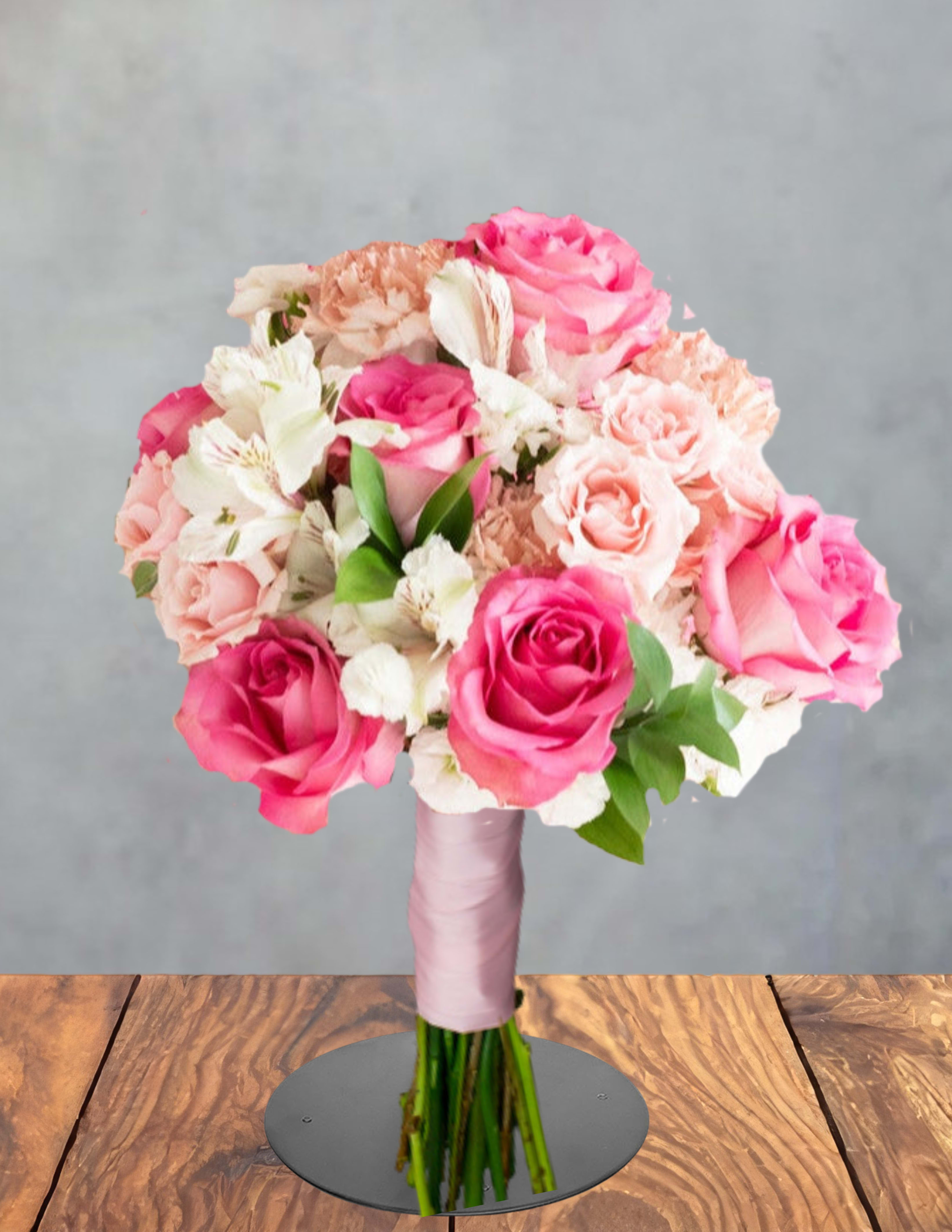  Prom Night Blush - Bright pink and soft peach roses lead this Prom Night Blush flower arrangement, a rounded hand-tied bouquet perfect for prom corsages, graduation gifts, or a special celebratory surprise. The combination of saturated pinks and creamy whites reads romantic and cheerful, making the recipient feel noticed and celebrated on an important night.  White alstroemeria and pale carnations add delicate texture and lasting fullness alongside the roses; stems are gathered tightly in a classic rounded design and finished with a pale pink ribbon and bouquet wrap for a polished, gift-ready presentation. Sized to be held comfortably, it's an elegant choice for teens and young adults or anyone you want to honor with soft, pastel-hued blooms.