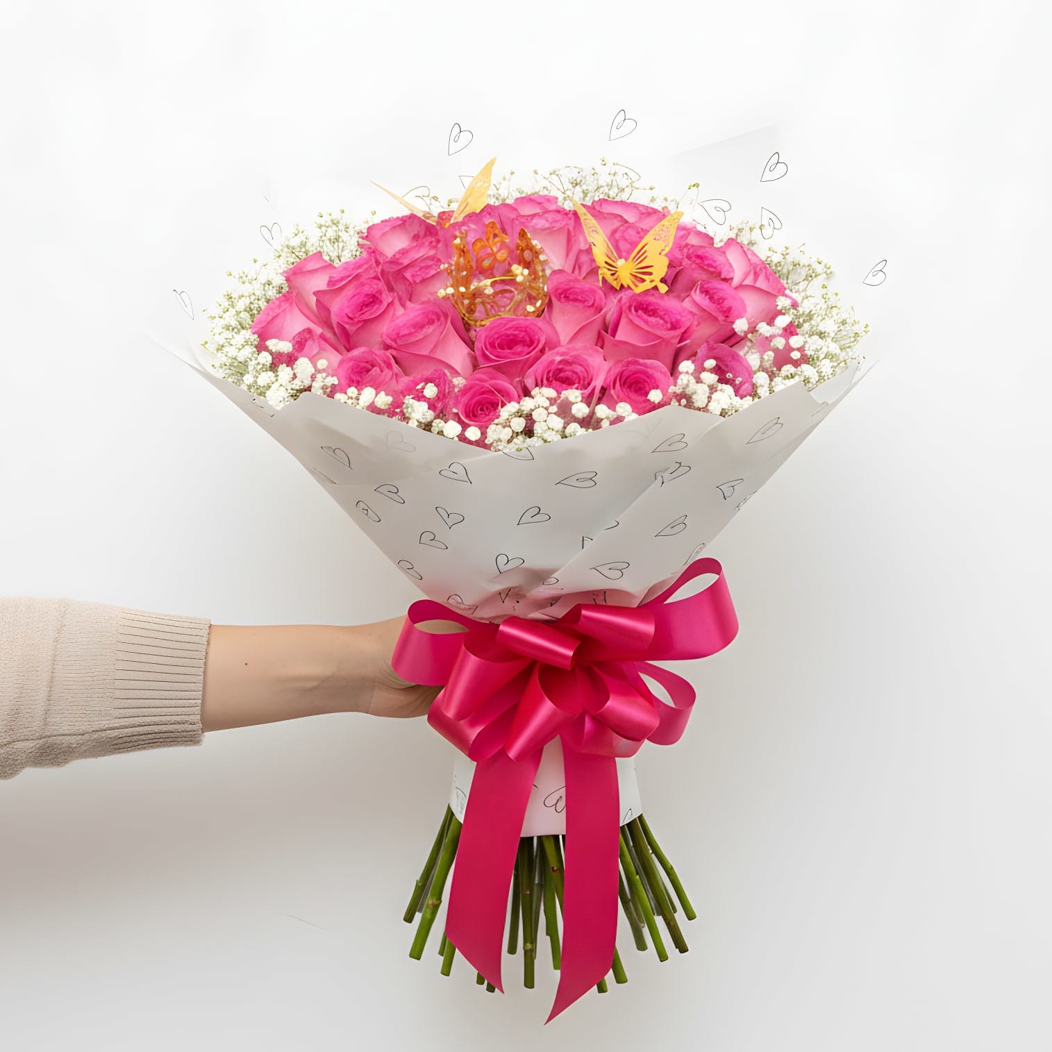 Princess Blush - Soft, playful, and full of charm, Princess Blush is designed to make any moment feel extra special. Featuring a lush arrangement of 50 vibrant pink roses, this bouquet is accented with delicate baby’s breath and wrapped in a stylish, heart-patterned design.  Finished with a statement satin bow, a decorative crown, and elegant butterfly accents, this bouquet brings a touch of whimsy and luxury together. It’s the perfect choice for birthdays, celebrations, or anyone who deserves to feel like royalty.  Fun, feminine, and eye-catching, Princess Blush is a beautiful way to celebrate love, joy, and unforgettable moments.