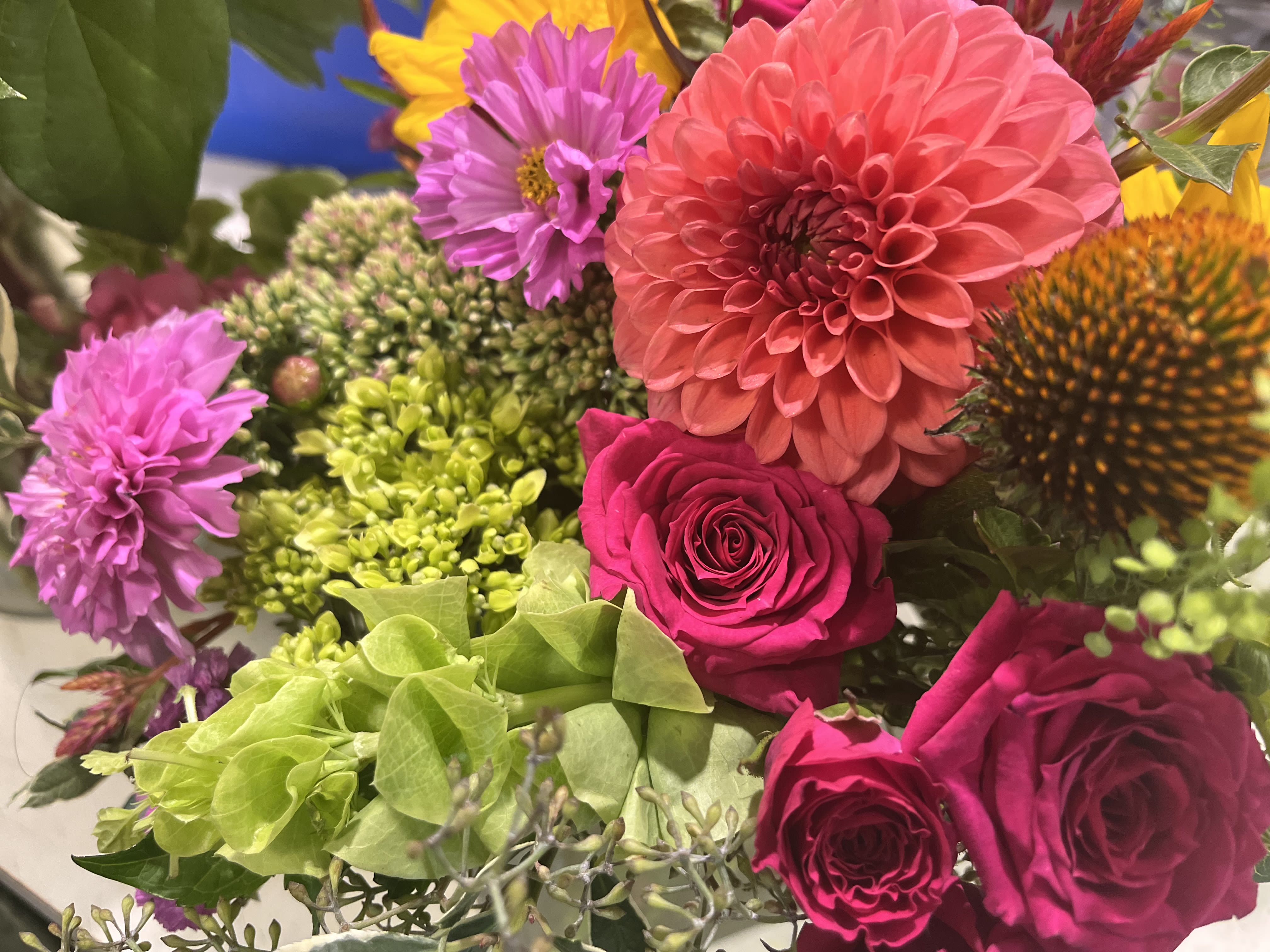 Mixed bouquet with pink dahlias, roses, and purple blooms