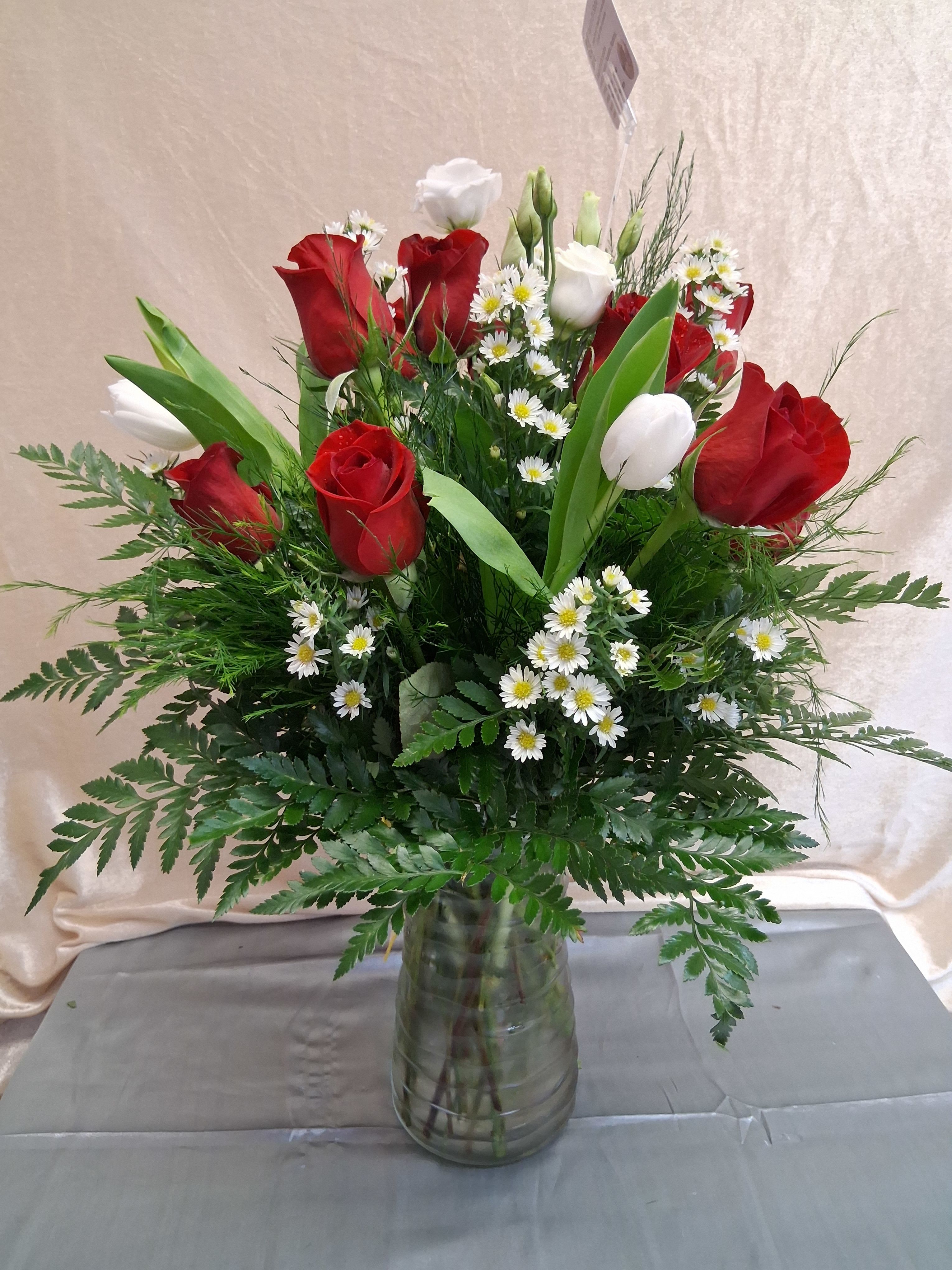 One dozen roses with white fillers - One dozen red roses with assorted white fillers
