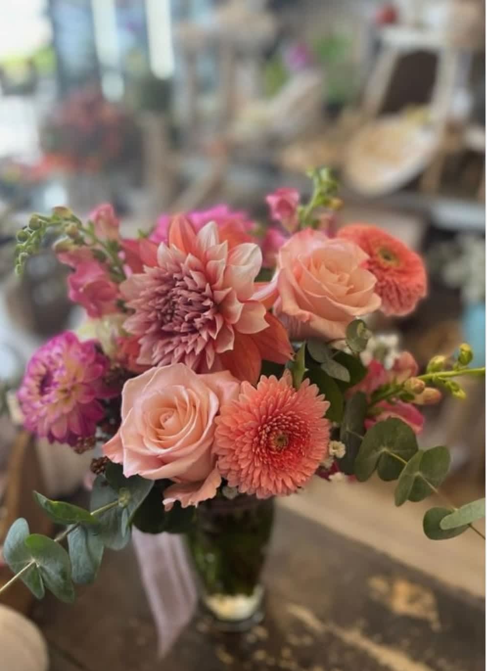 Bouquet of pink and peach flowers in a glass vase