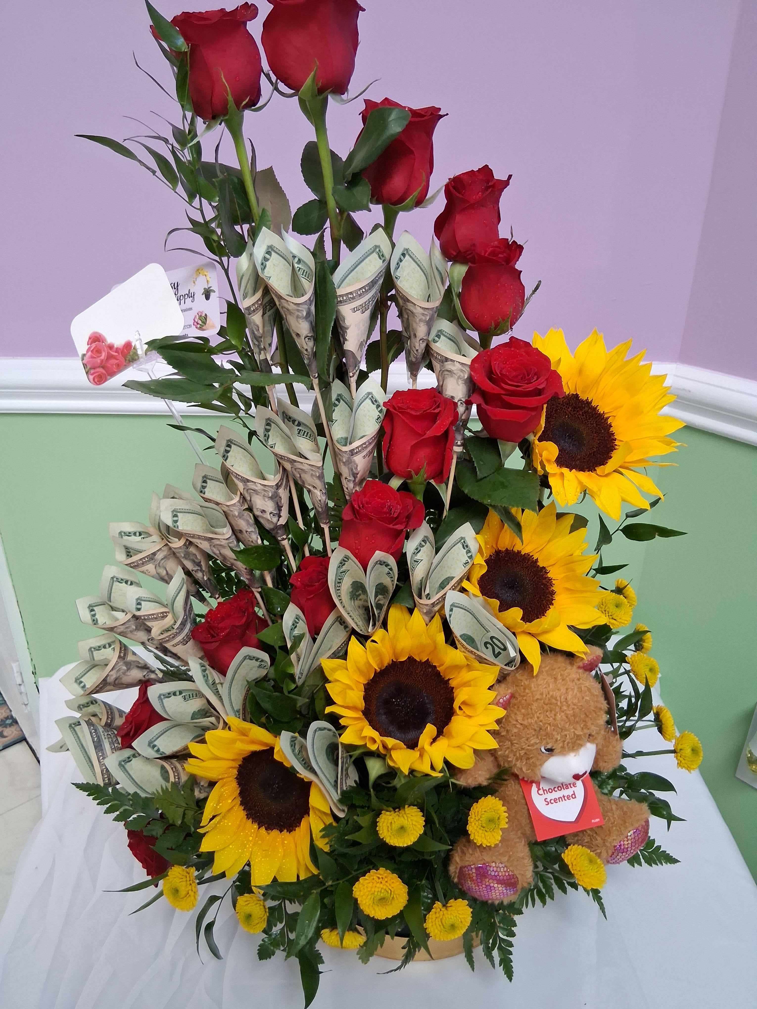 Money arrangement 1 dozen red roses with sunflower - Please read - This arrangement will come without money or fake money unless provided to us at our local store. Otherwise you will be purchasing the arrangement itself.