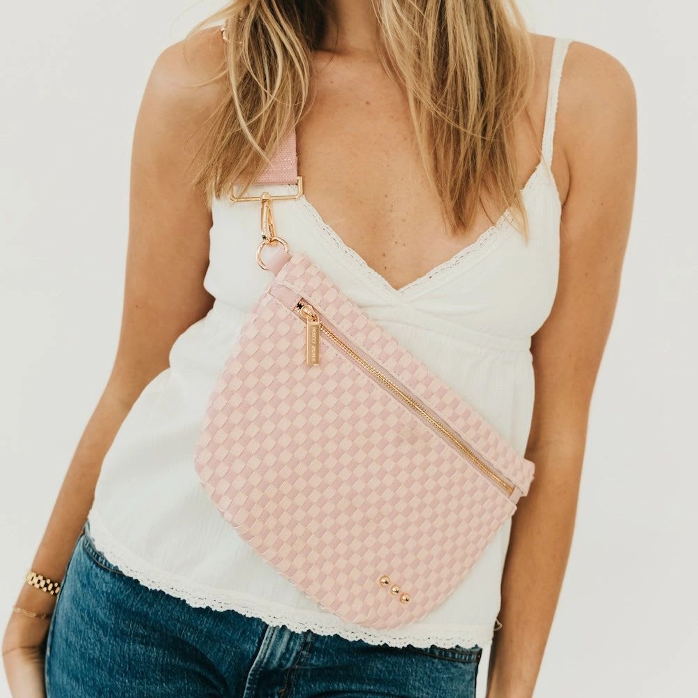 Blush Bum Bag - Meet the Westlyn Woven Bum Bag! Gorgeous woven vegan leather! Beautiful hardware with a zipper closure with beige and black chevron interior, and a zippered slash pocket on the inside. This crossbody bag is the perfect accessory to elevate any outfit! Available in 25 colors perfect for your everyday, date night, game day, travel and more!   Measurements: 12"L x 8"H x 24"-46" strap
