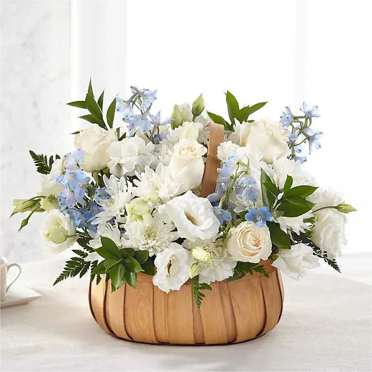 Sincerely Heartfelt Basket - Fresh blue and white flowers are designed to share your heartfelt thoughts for the loss of a loved one. Our talented designers beautifully craft roses, lisianthus and delphinium to create the loving sentiment that is sent with our Sincerely Heartfelt Basket. Details The Premium Basket is approximately 14"H x 18"W. Designed by florists, ready to display. For long–lasting blooms, add water daily.