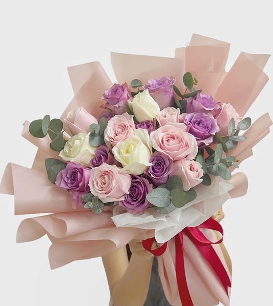 Sweet mix  Rose  wrapped Bouque - Elevate any occasion with this stunning bouquet featuring  24 purple and  delicate pink and white roses. Wrapped in elegant pastel paper and tied with a soft ribbon, this arrangement exudes grace, charm, and sophistication, making it the perfect gift for expressing admiration and love.